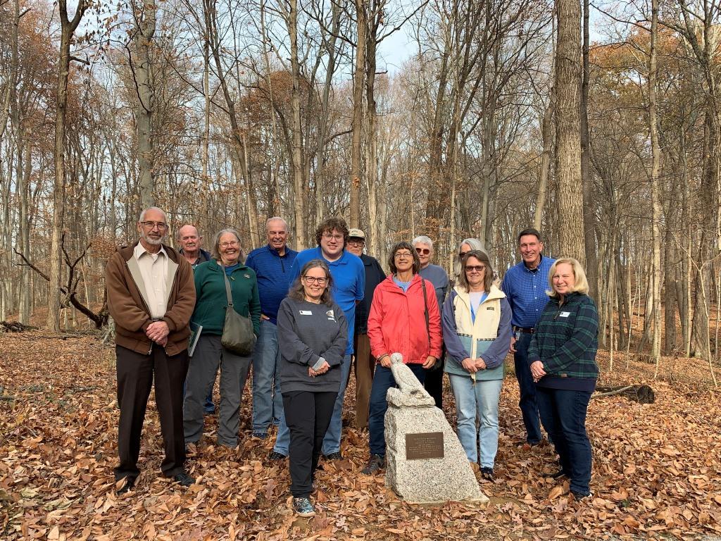 photo of volunteers with hawk sculpture dedicated to all volunteers past, present, future